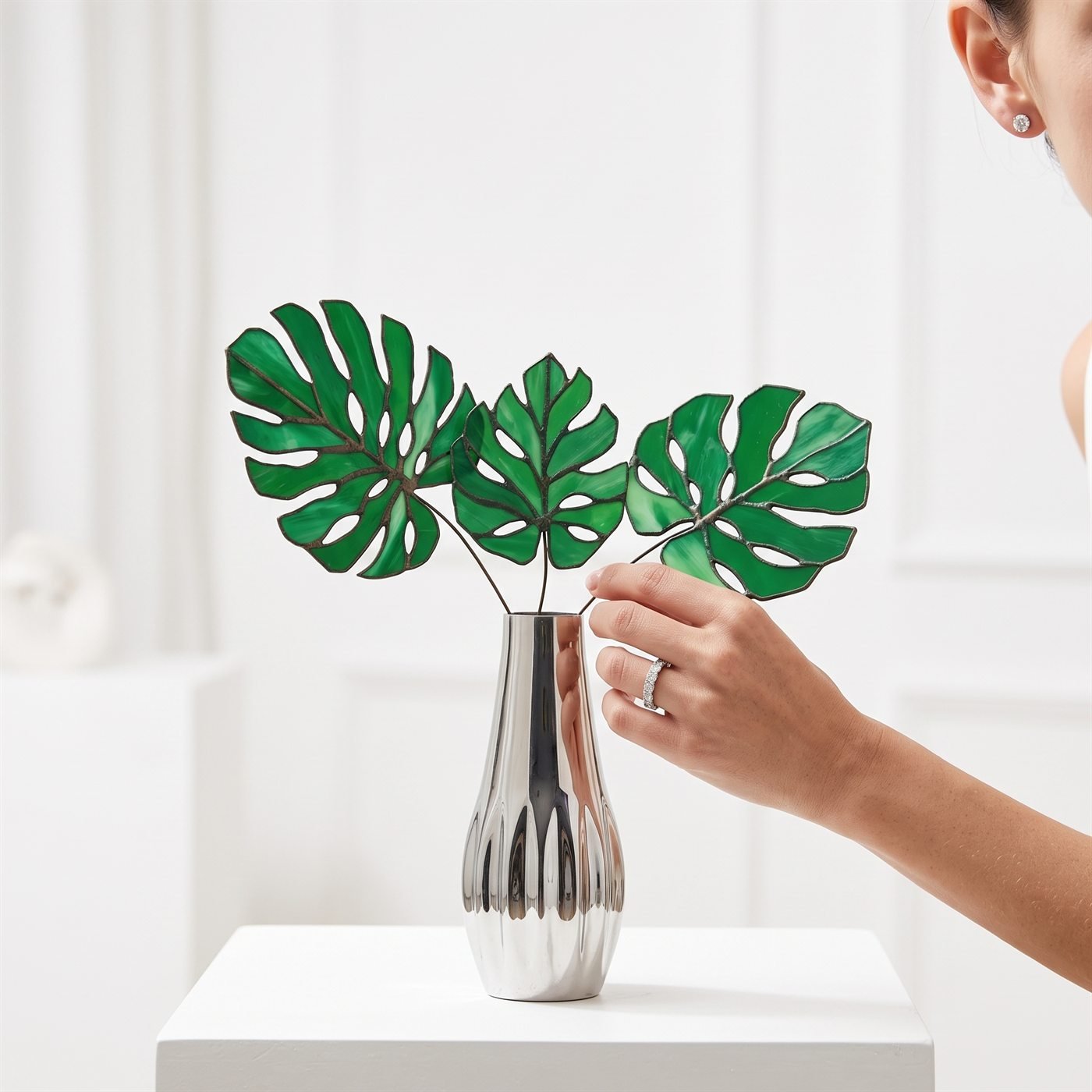 In use – Stained-glass monstera leaves · silver vase